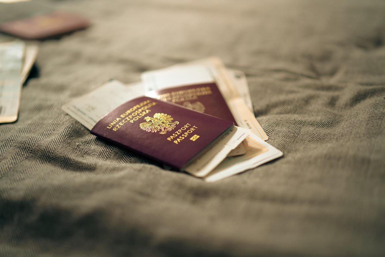 gallery-4 A close-up of a Polish passport and travel documents placed on a fabric surface, symbolizing travel and identity.