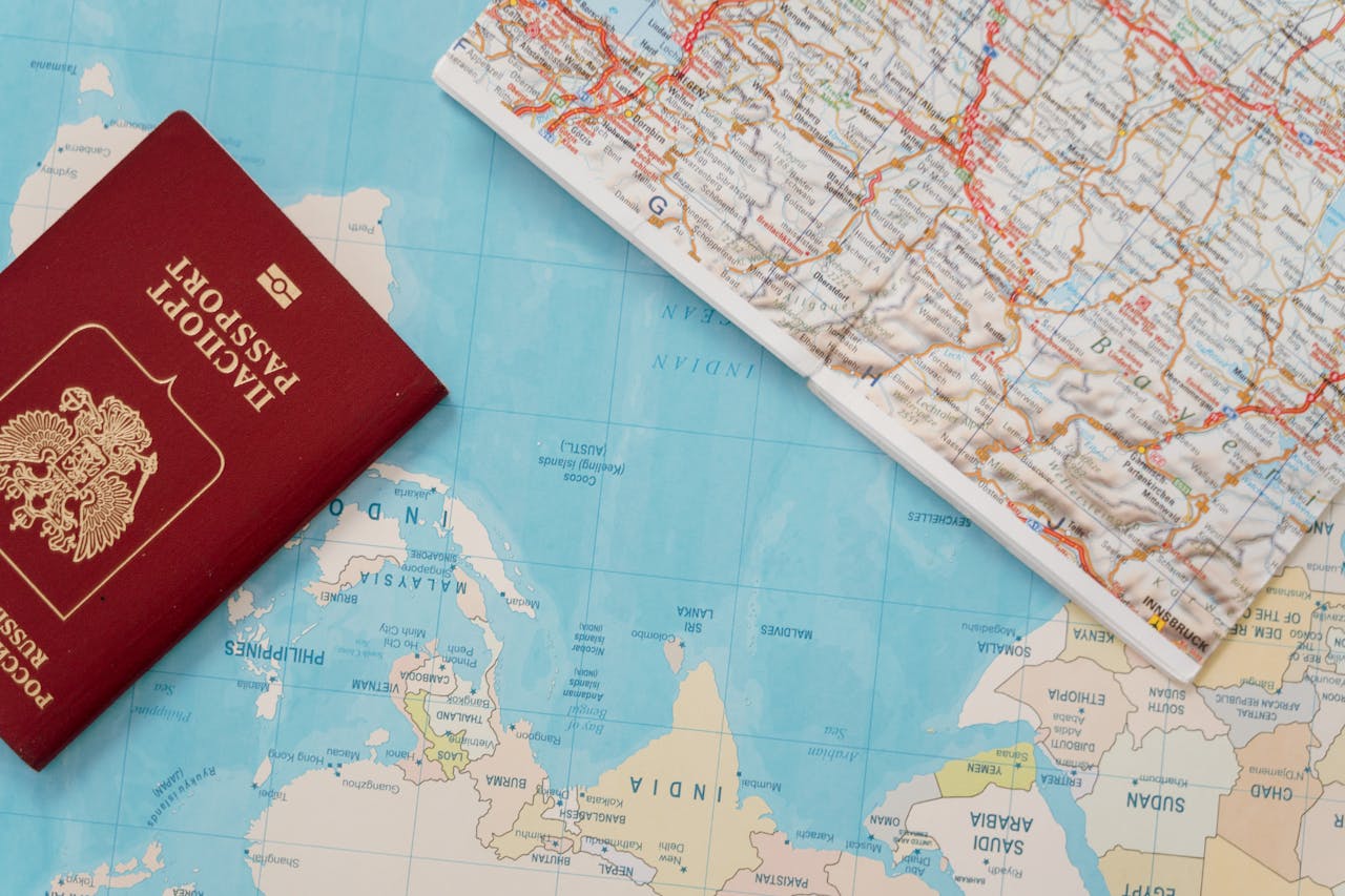 contact-img Flat lay of a passport and map, symbolizing travel adventure and exploration.