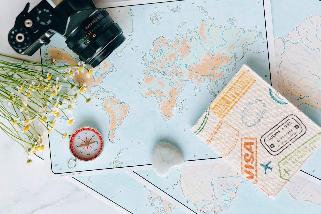 services-img Flat lay of travel essentials: maps, camera, compass, and travel journal for planning adventures.